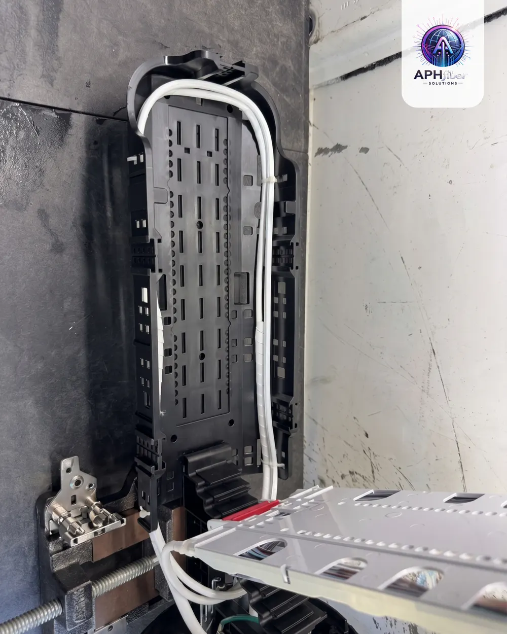 Open fiber enclosure mounted on a vehicle with cable entering from below