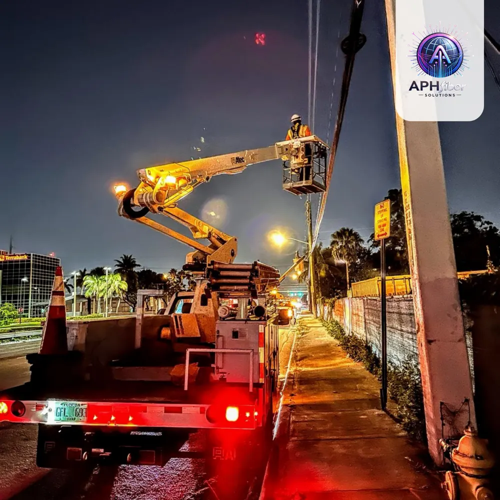 Technician in a bucket truck working on overhead lines at night
