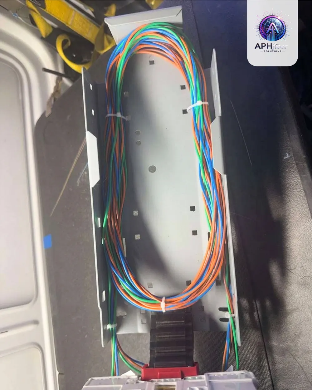 Colored fiber loops stored in a splice tray inside a van